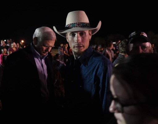 Johnny Langendorff, one of the two men who chased after suspected killer Devin Kelley, looks on during a vigil in Sutherland Springs, Texas on November 6, 2017, a day after a mass shooting that killed 26 people.A gunman wearing all black armed with an assault rifle opened fire on a small-town Texas church during Sunday morning services, killing 26 people and wounding 20 more in the last mass shooting to shock the United States. / AFP PHOTO / Mark RALSTON