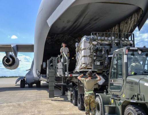 Technical Sergeant Heather Boutin works with an Senior Airman Megan Lenling, both Air Transportation Specialists with the 133rd Airlift Wing’s Air Transportation Function to direct and onload palletized cargo from a forklift onto a C-17 Globemaster III during a recent Denton Humanitarian Assistance Program mission. The medical supplies are destined for people with disabilities in Danli, Honduras. The equipment was graciously donated by a St Paul based organization, Interfaith Service to Latin America. (U.S. Air Force photo by Tech. Sgt. Bristol L. Evasco)