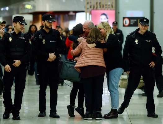 TOPSHOT - The mayor of Caracas, Antonio Ledezma (C) hugs his wife Mtzy Capriles (2-R) and his daughter Antoneta upon his arrival to the Barajas Airport on November 18, 2017 in Madrid. Ledezma arrived from Bogota to Spain on November 18 after escaping house arrest in the Venezuelan capital, after having been accused of conspiracy against the government of Nicolas Maduro. / AFP PHOTO / OSCAR DEL POZO