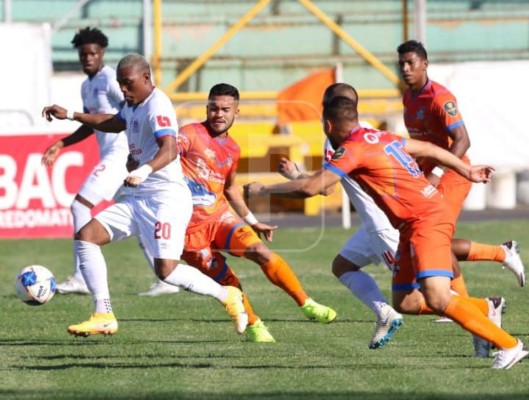 Deybi Flores conduce la pelota ante la marca de los jugadores de la UPN.