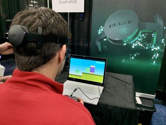 NextMind, a French Start-Up, exhibits its headset that decodes brainwaves and translates the users intention on the screen, enabling him to 'shoot' ducks in a video game without hitting a button during the CES Unveiled event at the 2020 Consumer Electronics Show (CES) in Las Vegas, Nevada, on January 5, 2020. - CES is one of the largest tech shows on the planet, showcasing more than 4,500 exhibiting companies representing the entire consumer technology ecosystem. (Photo by Julie JAMMOT / AFP)