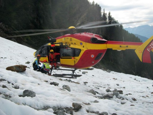 This handout picture taken on July 27, 2017, and released on July 28, 2017, by Daniel Roche, who discovered body remains on the Mont Blanc, shows French rescuers beside a helicopter, working at the site where the remains were found and which could belong to a victim of one of two Air India crashes which occured in 1950 and 1966, on the Mont Blanc massif, French Alps.The discovery was made on July 27, 2017, by Daniel Roche, who has been passionate for airplane crashes for 15 years, and has relentlessly scoured the Bossons glacier in the Mont Blanc Masssif, where crashed the 'Malabar Princess', a Lockheed Constellation, in 1950, and the 'Kangchenjunga', a Boeing 707, in 1966. / AFP PHOTO / HANDOUT / Daniel ROCHE / RESTRICTED TO EDITORIAL USE - MANDATORY CREDIT 'AFP PHOTO / DANIEL ROCHE' - NO MARKETING NO ADVERTISING CAMPAIGNS - DISTRIBUTED AS A SERVICE TO CLIENTS