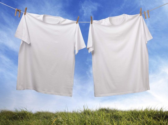 White t-shirt hanging on outdoor clothes line with blank front ready for logo or message