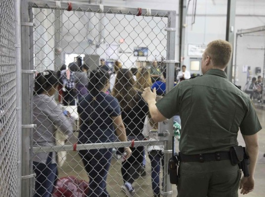 CORRECTION - This US Customs and Border Protection photo dated June 17, 2018 and obtained June 18, 2018 shows intake of illegal border crossers by US Border Patrol agents at the Central Processing Center in McAllen, Texas on May 23, 2018. / AFP PHOTO / US Customs and Border Protection / Handout / RESTRICTED TO EDITORIAL USE - MANDATORY CREDIT 'AFP PHOTO / US CUSTOMS AND BORDER PROTECTION/HANDOUT' - NO MARKETING NO ADVERTISING CAMPAIGNS - DISTRIBUTED AS A SERVICE TO CLIENTS / The erroneous mentions appearing in the metadata of this photo by the US Customs and Border Protection has been modified in AFP systems in the following manner: [photo dated June 17, 2018 and obtained June 18, 2018] and not as previously stated. Please immediately remove the erroneous mentions from all your online services and delete them from your servers. If you have been authorized by AFP to distribute them to third parties, please ensure that the same actions are carried out by them. Failure to promptly comply with these instructions will entail liability on your part for any continued or post notification usage. Therefore we thank you very much for all your attention and prompt action. We are sorry for the inconvenience this notification may cause and remain at your disposal for any further information you may require.