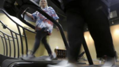 Gym members use as treadmill to warm up for a morning exercise class at Downsize Fitness Thursday, Jan. 3, 2013, in Addison, Texas. Downsize Fitness is a selective gym where the rule is that new members must tip the scales. New members are weighed and have their body mass index measured. (AP Photo/LM Otero)