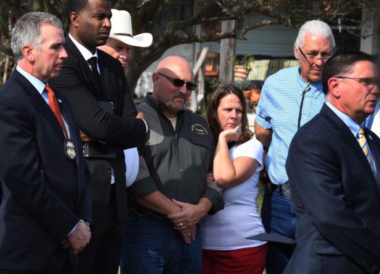 Pastor Frank Pomeroy (center L) and his wife Sherri listen during a press conference at the entrance to the First Baptist Church, after a mass shooting that killed 26 people in Sutherland Springs, Texas on November 6, 2017.A gunman wearing all black armed with an assault rifle opened fire on a small-town Texas church during Sunday morning services, killing 26 people and wounding 20 more in the last mass shooting to shock the United States. / AFP PHOTO / Mark RALSTON