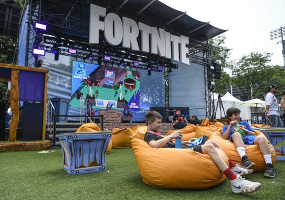 NEW YORK, NEW YORK - JULY 26: Fans attend day one of the Fortnite World Cup Finals at Arthur Ashe Stadium on July 26, 2019 in the Queens borough of New York City. Sarah Stier/Getty Images/AFP== FOR NEWSPAPERS, INTERNET, TELCOS & TELEVISION USE ONLY ==