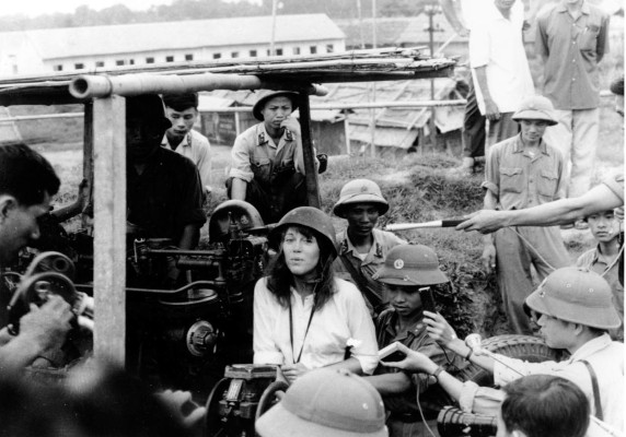 FILE - In this 1972 file photo, American actress and activist Jane Fonda is surrounded by soldiers and reporters as she sings an anti-war song near Hanoi during the Vietnam War in July 1972. A Vietnamese doctor said that a Vietnam war underground bunker found at a Hanoi hotel in the summer 2011 sheltered Fonda, American folk singer Joan Baez and other foreign war correspondents during the Christmas Bombings in 1972. (AP Photo/NIHON DENPA NEWS, File) JAPAN OUT