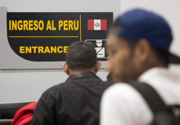 Venezuelan nationals visas petitions are attended after midnight at the binational border attention centre (CEBAF) in Tumbes, northern Peru on August 24, 2018.Ecuador opened a 'humanitarian corridor' to allow masses of migrants escaping Venezuela's free-falling economy to stream towards the Peruvian border Friday August 24, hours before Lima puts new restrictions on entry into effect. / AFP PHOTO / CRIS BOURONCLE