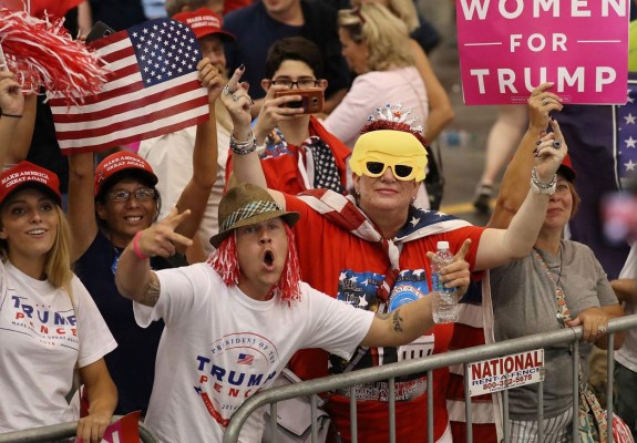 MELBOURNE, FL - FEBRUARY 18: A woman shows off her middle fingers as she and others look on at the media during a campaign rally by President Donald Trump at the AeroMod International hangar at Orlando Melbourne International Airport on February 18, 2017 in Melbourne, Florida. President Trump is holding his rally as he continues to try to push his agenda through in Washington, DC. Joe Raedle/Getty Images/AFP== FOR NEWSPAPERS, INTERNET, TELCOS & TELEVISION USE ONLY ==
