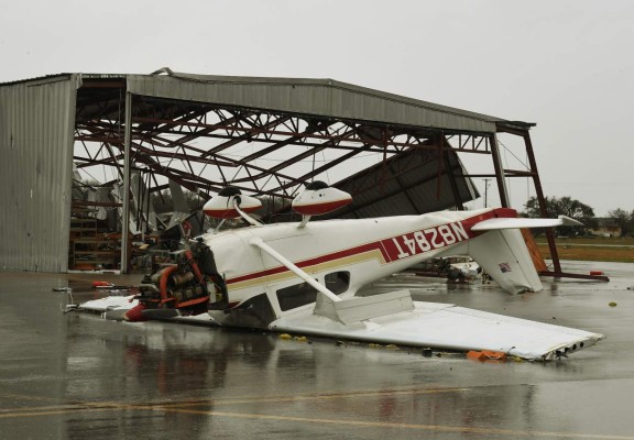 A light plane sits upside done at Rockport Airport after heavy damage when Hurricane Harvey hit Rockport, Texas on August 26, 2017. Hurricane Harvey slammed into the Texas coast late Friday, unleashing torrents of rain and packing powerful winds, the first major storm to hit the US mainland in 12 years. / AFP PHOTO / MARK RALSTON