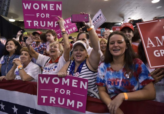 Supporters cheer as US Republican presidential nominee Donald Trump speaks during a rally in the Special Events Center of the Florida State Fairgrounds in Tampa, Florida on November 5, 2016. / AFP PHOTO / MANDEL NGAN