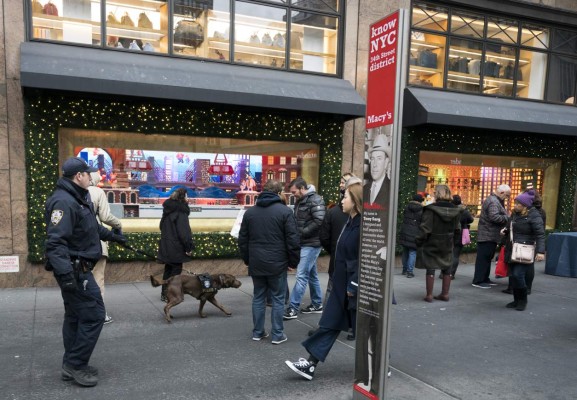 New York police department officers patrol the area around Herald Square on December 12, 2017 in New York. The United States unveiled federal terrorism charges against the Bangladeshi driver who detonated a bomb in a New York subway passageway, after allegedly being inspired by the Islamic State group and self-radicalizing as early as 2014. / AFP PHOTO / DON EMMERT