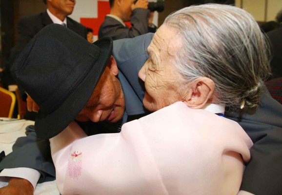 South Korean Gwon O-Hui (R), 92, hugs her North Korean relative Ri Han-Sik (L), 87, during a separated family reunion meeting at the Mount Kumgang resort on the North's southeastern coast on October 20, 2015. Nearly 400 mostly elderly South Koreans, carrying gifts of warm clothes, cash and cosmetics, crossed into North Korea for a rare meeting with relatives they have either never met or last saw more than six decades ago. REPUBLIC OF KOREA OUT NO ARCHIVES RESTRICTED TO SUBSCRIPTION USE AFP PHOTO / YONHAP
