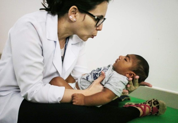 RECIFE, BRAZIL - JUNE 02: Dr. Stella Guerra performs physical therapy on an infant born with microcephaly at Altino Ventura Foundation on June 2, 2016 in Recife, Brazil. Microcephaly is a birth defect linked to the Zika virus where infants are born with abnormally small heads. The Brazilian city of Recife and surrounding Pernambuco state remain the epicenter of the Zika virus outbreak, which has now spread to many countries in the Americas. A group of health experts recently called for the Rio 2016 Olympic Games to be postponed or cancelled due to the Zika threat but the WHO (World Health Organization) rejected the proposal. (Photo by Mario Tama/Getty Images)