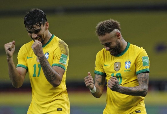 Brazil's Neymar (R) celebrates with teammate Lucas Paqueta after scoring a penalty against Ecuador during their South American qualification football match for the FIFA World Cup Qatar 2022 at the Jose Pinheiro Borda stadium, better known as Beira-Rio, in Porto Alegre, Brazil, on June 4, 2021. (Photo by SILVIO AVILA / AFP)