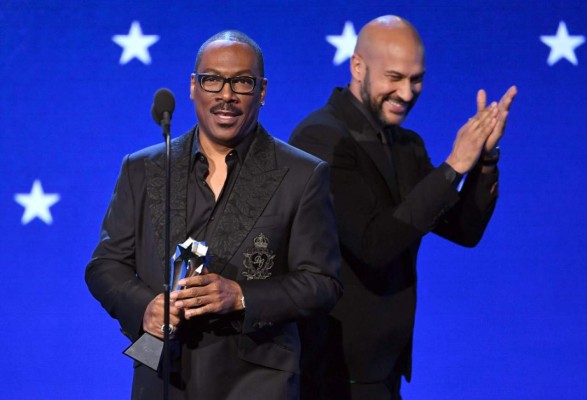 SANTA MONICA, CALIFORNIA - JANUARY 12: (L-R) Eddie Murphy accepts the Lifetime Achievement Award from Keegan-Michael Key onstage during the 25th Annual Critics' Choice Awards at Barker Hangar on January 12, 2020 in Santa Monica, California. Kevin Winter/Getty Images for Critics Choice Association/AFP