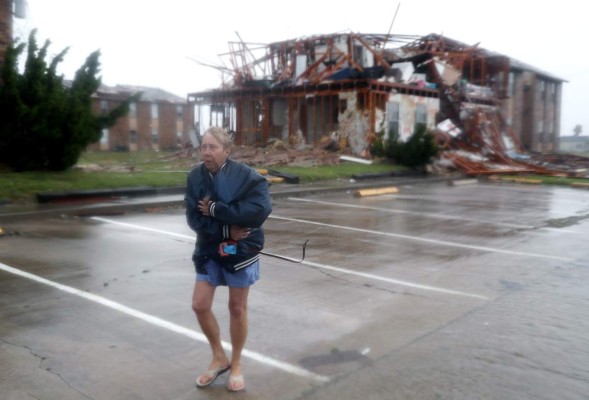 ROCKPORT, TX - AUGUST 26: Jacque McKay walks through the apartment complex where she lives and road out the storm after Hurricane Harvey destroyed many of the apartments on August 26, 2017 in Rockport, Texas. Ms. McKay said she was able to rescue her dog but lost pretty much everything else. Harvey made landfall shortly after 11 p.m. Friday, just north of Port Aransas as a Category 4 storm and is being reported as the strongest hurricane to hit the United States since Wilma in 2005. Forecasts call for as much as 30 inches of rain to fall in the next few days. Joe Raedle/Getty Images/AFP