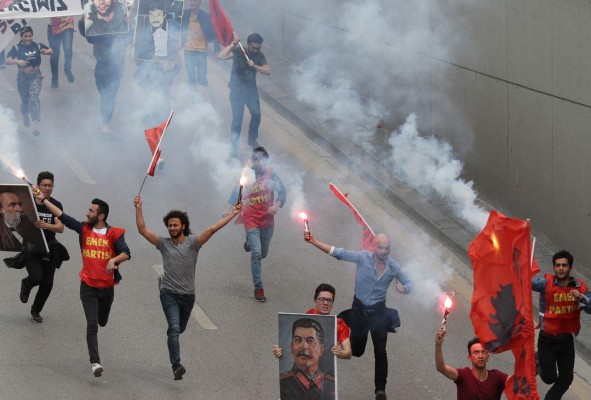 Mainly students hold images of Marxist leaders, flags and shout slogans during a May Day or Labour Day rally in Ankara on May 1, 2019. (Photo by Adem ALTAN / AFP)