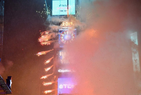 People watch the countdown to 2019 during New Year's Eve celebration in Times Square, New York, on on December 31, 2018. (Photo by Angela Weiss / AFP)