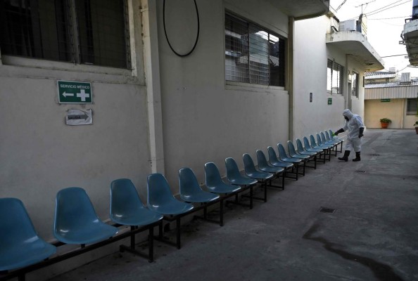 A municipal worker sanitizes the San Salvador Municipal Mayor's building as a precaution against a possible arrival of the new Coronavirus, COVID-19, in San Salvador, on March 12, 2020. (Photo by MARVIN RECINOS / AFP)