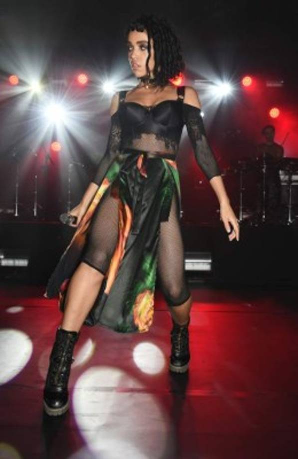 La falda de seda con estampados de flores cubría sus partes íntimas. Y complementó el look con botas de cuero. ¡Hot!