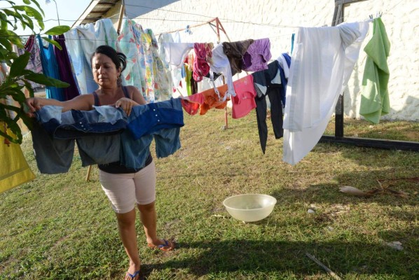 Cuban Noetsi Fuentes hangs laundry to dry at a Methodist church sheltering 35 Cuban refugees in Liberia, Guanacaste, Costa Rica, on December 29, 2015. Costa Rica on Tuesday warned it should not be seen as an 'open bridge' to America after striking a deal to start shipping out stranded Cuban migrants to other Central American countries. AFP PHOTO/Carlos GONZALEZ