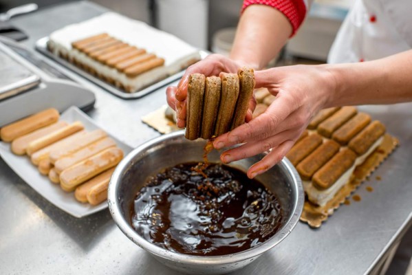 Making tiramisu cookies with savoiardi and mascarpone in the restaurant kitchen