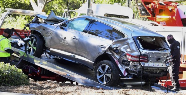 A tow truck recovers the vehicle driven by golfer Tiger Woods in Rancho Palos Verdes, California, on February 23, 2021, after a rollover accident. - Woods was hospitalized Tuesday after a car crash in which his vehicle sustained 'major damage,' the Los Angeles County Sheriff's department said. Woods, the sole occupant, was removed from the wreckage by firefighters and paramedics, and suffered 'multiple leg injuries,' his agent said in a statement to US media. (Photo by Frederic J. BROWN / AFP)