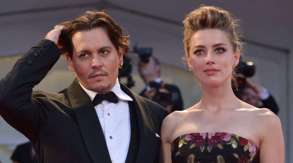 US actress Amber Heard arrives with her husband US actor Johnny Depp for the screening of the movie 'The Danish Girl' presented in competition at the 72nd Venice International Film Festival on September 5, 2015 at Venice Lido. AFP PHOTO / TIZIANA FABI