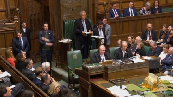 TOPSHOT - The Union flag flies atop the Houses of Parliament as EU flags held by demonstrators flutter in central London on April 4, 2019. - Britain's government redoubled its efforts Thursday to win over the main opposition party in a last-gasp bid to avoid a chaotic exit from the European Union next week. (Photo by Daniel LEAL-OLIVAS / AFP)