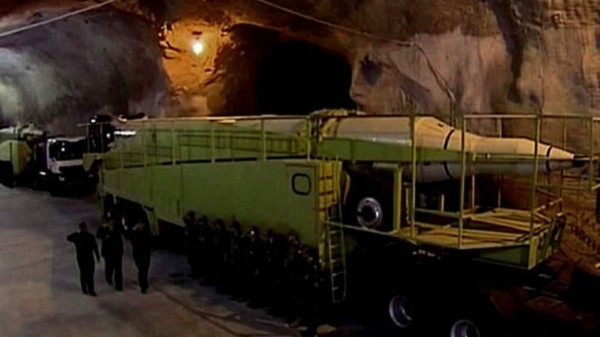 Iranian women cheer and wave their country's national flags as they attend the World Cup Qatar 2022 Group C qualification football match between Iran and Cambodia at the Azadi stadium in the capital Tehran on October 10, 2019. - The Islamic republic has barred female spectators from football and other stadiums for around 40 years, with clerics arguing they must be shielded from the masculine atmosphere and sight of semi-clad men. Women fans are attending the football match freely for the first time in decades, after FIFA threatened to suspend the country over its controversial male-only policy. (Photo by ATTA KENARE / AFP)