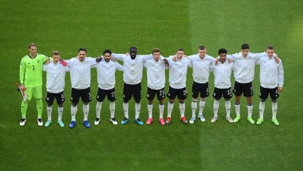 The Germany players listen to the national anthems during the UEFA EURO 2020 Group F football match between Portugal and Germany at Allianz Arena in Munich on June 19, 2021. (Photo by Matthias Hangst / POOL / AFP)