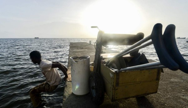 Disabled diver Ernesto McLean jumps from a dock into the water in Puerto Lempira, Honduras, on July 8, 2019. - Thousands of fishing divers of the Mosquitia region, where lobster diving industry is the most important incoming for the economy, suffer decompression sickness that can cause pain in the muscles and joints, cramps, numbness, nausea, permanent paralysis and even death. (Photo by Orlando SIERRA / AFP)