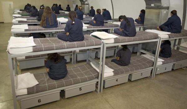 Raymondville, UNITED STATES: Female detainees turn their backs to the visiting media as instructed by Homeland Security officials inside Homeland Security's Willacy Detention Center, a facility with 10 giant tents that can house up to 2000 detained illegal immigrants, 10 May 2007 in Raymondville, Texas. The 65 million USD facility was constructed as part of Secure Border Initative last July and now where many of the former 'catch and release' illegals are detained for processing. AFP Photo/Paul J. Richards (Photo credit should read PAUL J. RICHARDS/AFP/Getty Images)