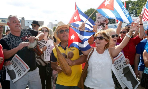 (FILES) This file photo taken on November 27, 2016 shows Cuban Americans celebrating the death of Cuban leader Fidel Castro on the streets in the Little Havana neighborhood of Miami Florida on November 27, 2016.Cuba commemorates the first anniversary of the death of revolutionary father Fidel Castro on November 25 as it looks ahead to the post-Castro era. / AFP PHOTO / RHONA WISE