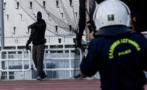 A PAOK Salonika's fan wears a mask with the color of his team ahead of the Greek Cup Final football match between AEK FC and PAOK Salonika at the Olympic stadium in Athens on May 12, 2018. / AFP PHOTO / ANDREAS PAPAKONSTANTINOU