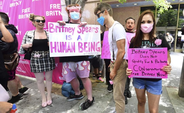 Fans and supporters hold signs as they gather outside the County Courthouse in Los Angeles, California on June 23, 2021, during a scheduled hearing in Britney Spears' conservatorship case. - Pop singer Britney Spears urged a US judge on June 23, to end a controversial guardianship that has given her father control over her affairs since 2008.'I just want my life back. It's been 13 years and it's enough,' she told a court hearing in Los Angeles during an emotional 20-minute address via videolink. (Photo by Frederic J. BROWN / AFP)