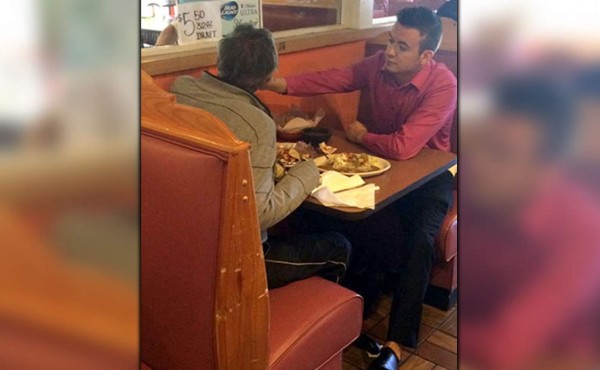 Mesero ayuda a comer a un cliente