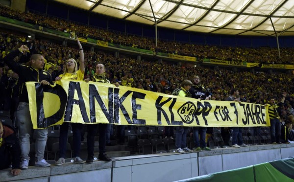 Liverpool's German manager Jurgen Klopp recieves his medal next to the Premier League trophy during the presentation following the English Premier League football match between Liverpool and Chelsea at Anfield in Liverpool, north west England on July 22, 2020. - Liverpool on Wednesday lifted the Premier League trophy at the famous Kop stand at Anfield after their final home game of the season. With no fans able to attend due to the COVID-19 coronavirus pandemic, Liverpool said the idea for the trophy lift was to honour the club's fans, but Liverpool manager Jurgen Klopp urged fans to respect social distancing measures, after thousands gathered around the club's stadium and in the city centre following their coronation as champions last month. (Photo by PHIL NOBLE / POOL / AFP) / RESTRICTED TO EDITORIAL USE. No use with unauthorized audio, video, data, fixture lists, club/league logos or 'live' services. Online in-match use limited to 120 images. An additional 40 images may be used in extra time. No video emulation. Social media in-match use limited to 120 images. An additional 40 images may be used in extra time. No use in betting publications, games or single club/league/player publications. /