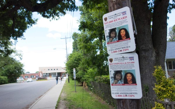 A reward poster hangs on a telephone pole near the local high school, asking for help in finding the killers of Nisa Mickens and Kayl Cuevas June 7, 2017 in Brentwood, New York.The town of Brentwood on New York's Long Island may look like an oasis of calm away from the hustle and bustle of Manhattan. But behind its timber homes and neat front yards, terror lurks. In this middle-class town 44 miles (70 kilometers) from New York and about the same distance from the glitzy Hamptons summer retreat for Manhattan's millionaires, the Latino street gang MS-13 exerts a brutal grip. / AFP PHOTO / Don Emmert