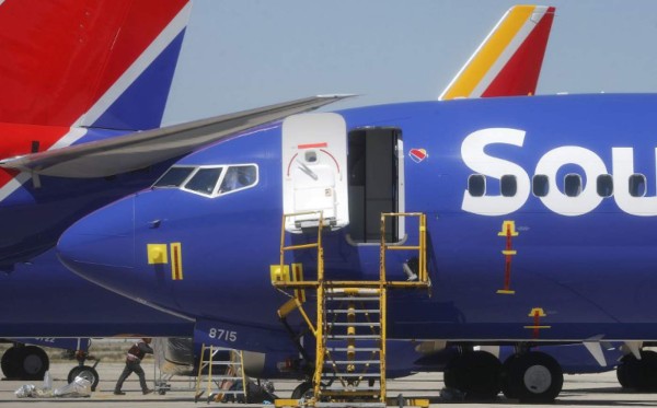 VICTORVILLE, CA - MARCH 27: A worker walks beneath a Southwest Airlines Boeing 737 MAX 8 aircraft parked at Southern California Logistics Airport on March 27, 2019 in Victorville, California. Southwest Airlines is waiting out a global grounding of the aircraft at the airport. Mario Tama/Getty Images/AFP