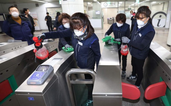 Seoul Metro employees spray disinfectant as part of efforts to prevent the spread of a new virus which originated in the Chinese city of Wuhan, at a subway station in Seoul on January 28, 2020. - South Korea will send chartered planes to the Chinese city of Wuhan this week to return hundreds of its citizens to Korea, the foreign ministry said, amid concerns about the spread of the SARS-like virus. (Photo by - / YONHAP / AFP) / - South Korea OUT / REPUBLIC OF KOREA OUT NO ARCHIVES RESTRICTED TO SUBSCRIPTION USE