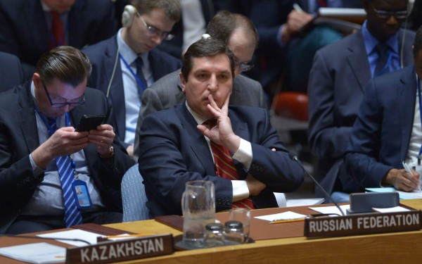 Russia's deputy UN ambassador, Vladimir Safronkov (C) listens as US Ambassador to the UN and UN security council president, Nikki Haleyspeaks during a United Nations Security Council meeting on Syria, at the UN headquarters in New York on April 7, 2017. / AFP PHOTO / Jewel SAMAD