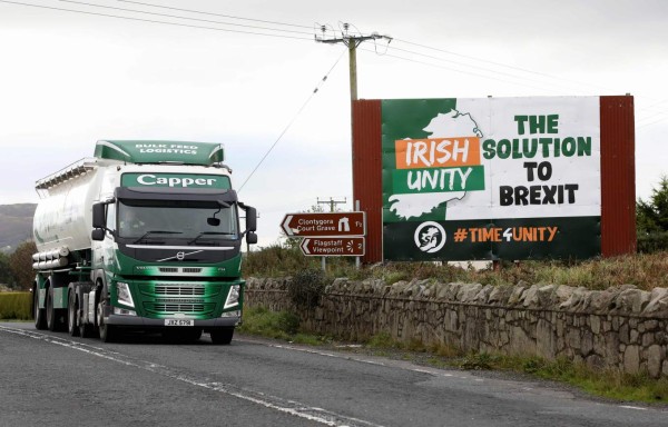 A lorry passes an anti-Brexit pro-Irish unity billboard seen from the Dublin road in Newry, Northern Ireland, on October 1, 2019 on the border between Newry in Northern Ireland and Dundalk in the Irish Republic. - Britain will give the EU new proposals for a Brexit deal 'shortly', Prime Minister Boris Johnson said on October 1, but rejected reports it would see customs posts along the Irish border. (Photo by PAUL FAITH / AFP)