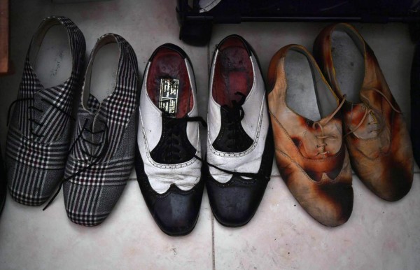 View of Pachuco-style shoes in the house of a Pachuco in Tepito neighborhood in Mexico City on August 22, 2017. Wearing their feathered hats, colorful tank tops, gold chains on the lapel and patent leather shoes, the Pachucos - the subculture that characterized Mexican gangs set up in the United States in the 1940s - continue to dance to the rhythm of legendary mambo Salons in Mexico. / AFP PHOTO / YURI CORTEZ / TO GO WITH AFP STORY by YEMELI ORTEGA