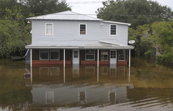 BEAUMONT, TX - SEPTEMBER 20: A house sits on the flooded waters on highway 124 on September 20, 2019 in Beaumont, Texas. Gov. Greg Abbott has declared much of Southeast Texas disaster areas after heavy rain and flooding from the remnants of Tropical Depression Imelda dumped more than two feet of water across some areas. Thomas B. Shea/Getty Images/AFP