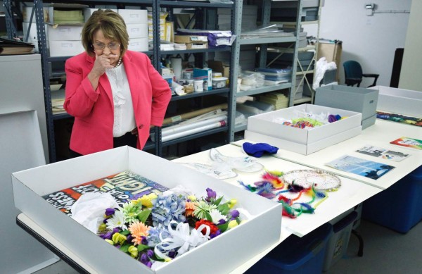 Teresa Jacobs, Mayor of Orange County, Florida, looks over artifacts left as meorials in the wake of the Pulse nightclub shootings, at the History Center in Orlando, Florida on June 9, 2017. The memorial items are being preserved and will be displayed in the 'One Orlando Collection' at the center, along with a digital gallery, as a historical record for current and future generations. In the deadliest mass shooting in US history, 49 people were killed at the gay nightclub on June 12, 2016. / AFP PHOTO / Gregg Newton