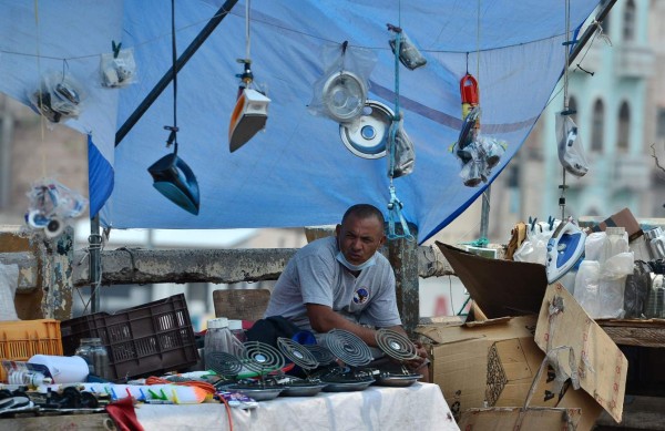 A street vendor waits for customers at a stall in Tegucigalpa on May Day, May 1, 2020, amid the COVID-19 coronavirus pandemic. - With strict social distancing rules in most countries to halt the spread of the novel coronavirus, many union leaders opted to delay gatherings or move events online faced with the COVID-19 outbreak that has killed more than 233,000 people worldwide. (Photo by Orlando SIERRA / AFP)