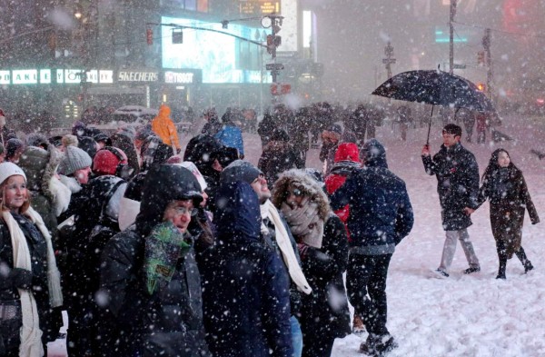 NEW YORK, NY - JANUARY 23: Pedestrians walk through the snowy streets near Times Square as all cars but emergency vehicles are banned from driving on the road on January 23, 2016 in New York City. The Northeast and parts of the South are experiencing heavy snow and ice from a slow moving winter storm. Numerous deaths from traffic accidents have been reported as the storm moves up the coast. Yana Paskova/Getty Images/AFP== FOR NEWSPAPERS, INTERNET, TELCOS & TELEVISION USE ONLY ==